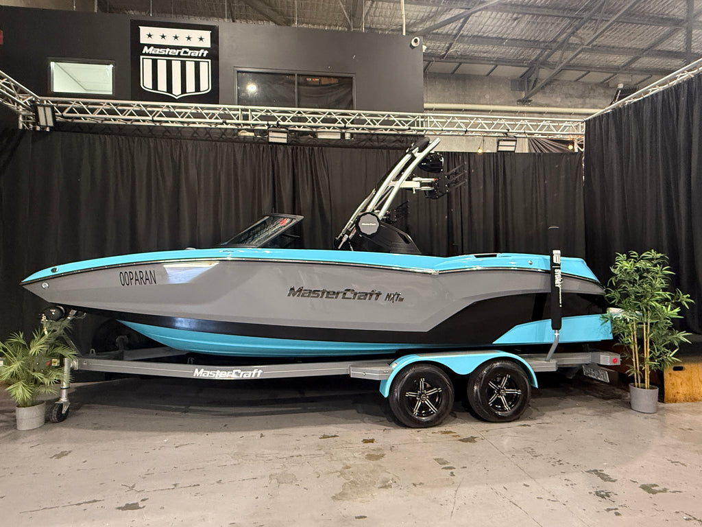 2022 MasterCraft NXT22 in blue, grey and black, side view