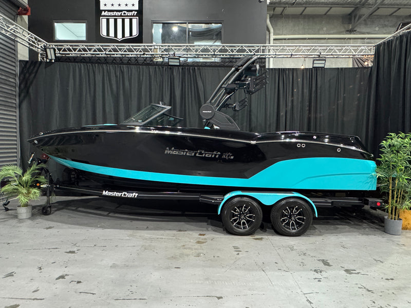 2026 MasterCraft NXT23 — side profile against the black showroom backdrop