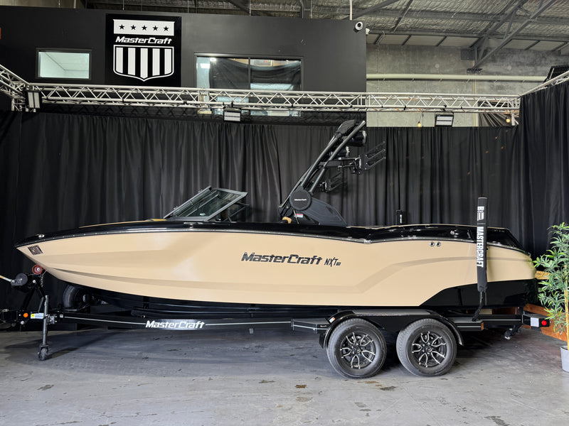 2026 MasterCraft NXT23 demo — full side profile against black showroom backdrop