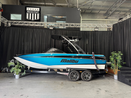 2014 Malibu WakeSetter 20VTX — blue and white side profile against black showroom backdrop