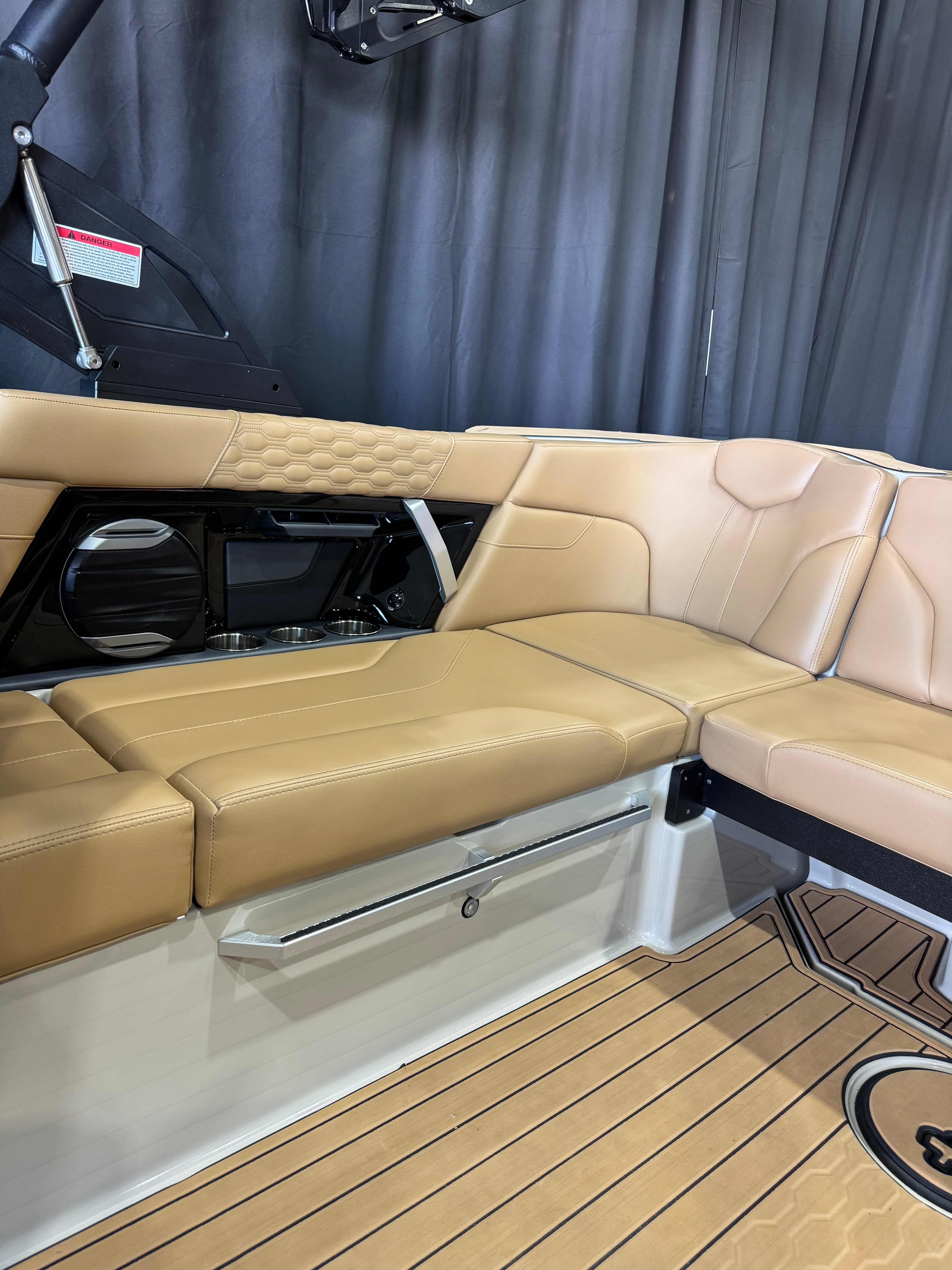 Tan leather MasterCraft XT22T boat seating with a quilted headrest and a wood-look floor, shown inside a boat cabin.