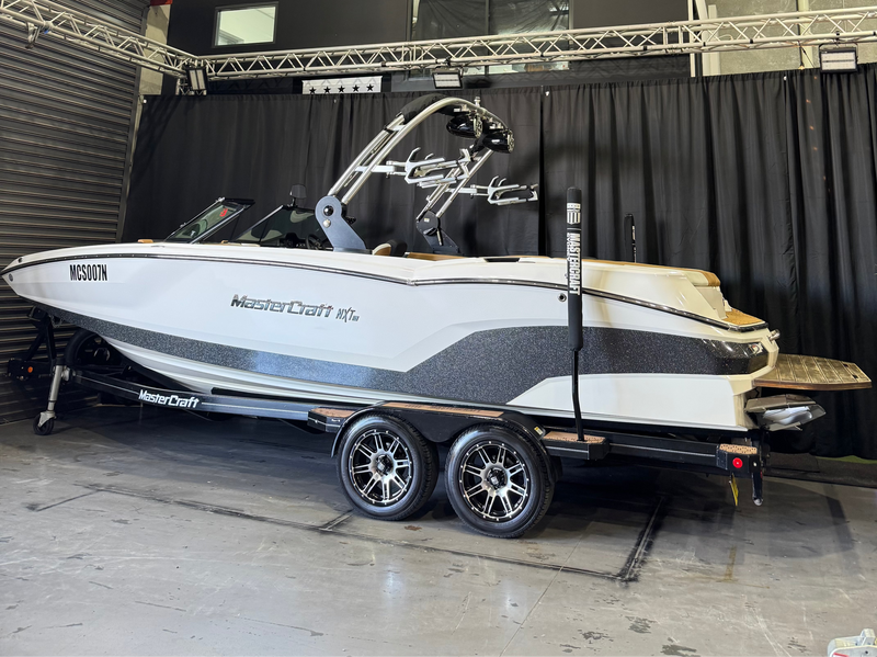 2021 MasterCraft NXT24 - side profile on trailer against black showroom curtains
